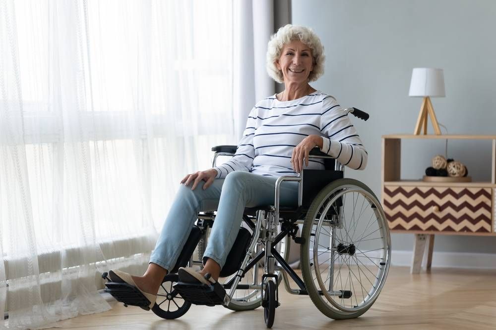 elderly woman smiling posing in wheelchair