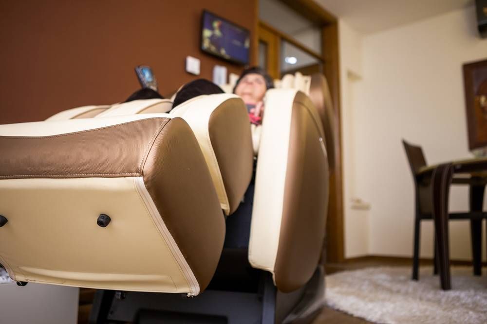 elderly woman using massage chair