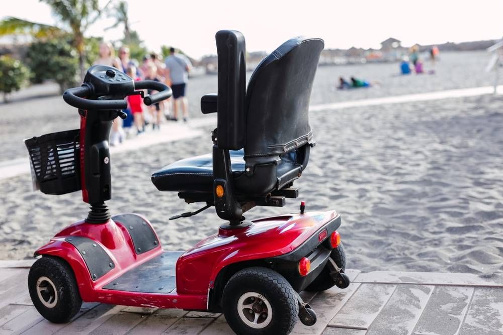 red mobility scooter on beach