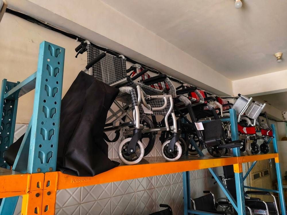 wheelchairs stored on metal racks