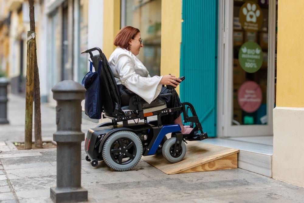 woman in electric wheelchair using wooden ramp